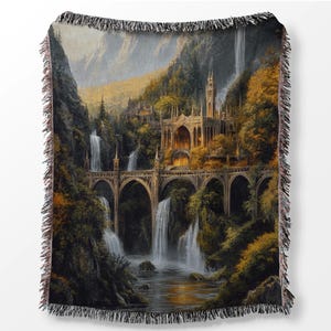 May include: A woven tapestry throw blanket featuring a fantasy landscape with a stone castle, waterfalls, and a bridge. The castle is surrounded by lush greenery and the waterfalls cascade down the cliffs. The bridge is made of stone and arches over a river.