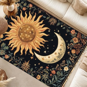 May include: A black and gold rug with a sun and moon design. The sun is surrounded by stars and the moon is surrounded by flowers. The rug has a floral border.