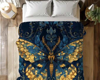 May include: A navy blue duvet cover with a gold and blue butterfly design. The butterfly has intricate details and is surrounded by floral patterns.