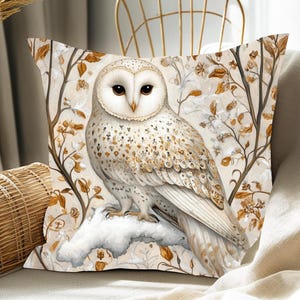 May include: A white owl with brown markings sits on a branch with white and brown leaves. The owl is perched on a snow-covered branch. The background is a white and brown floral pattern.