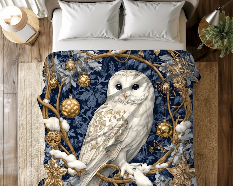 May include: A white owl with gold accents sits on a branch with gold ornaments hanging from it. The background is a dark blue with a wintery feel.