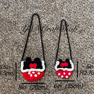 May include: Two crochet crossbody bags. The larger bag is 8 inches (20 cm) wide and 6.5 inches (16.5 cm) tall, and the smaller bag is 6 inches (15 cm) wide and 5 inches (12.7 cm) tall. Both bags are red with white polka dots and black tops with a red bow.