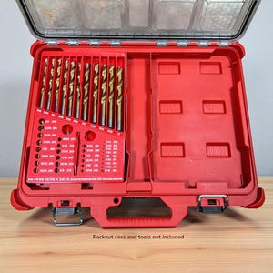 May include: A red drill bit organizer case with a clear lid, holding multiple gold-colored drill bits. The case has a handle and metal latches. The text "Packout case and tools not included" is visible at the bottom.