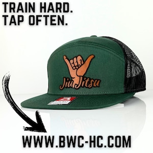 May include: Green and black baseball cap with a brown leather patch that says "Jiu Jitsu" and a hand gesture. The text "TRAIN HARD. TAP OFTEN." is in the top left corner of the image. The text "WWW.BWC-HC.COM" is in the bottom center of the image.