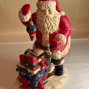 Vintage Ceramic Christmas Santa Standing Around Presents Holding Ornament