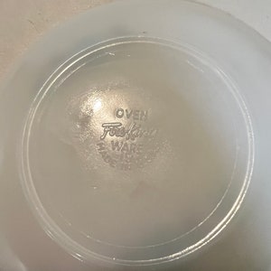 May include: White ceramic bowl with the words "OVEN Fire King WARE" printed on the bottom.