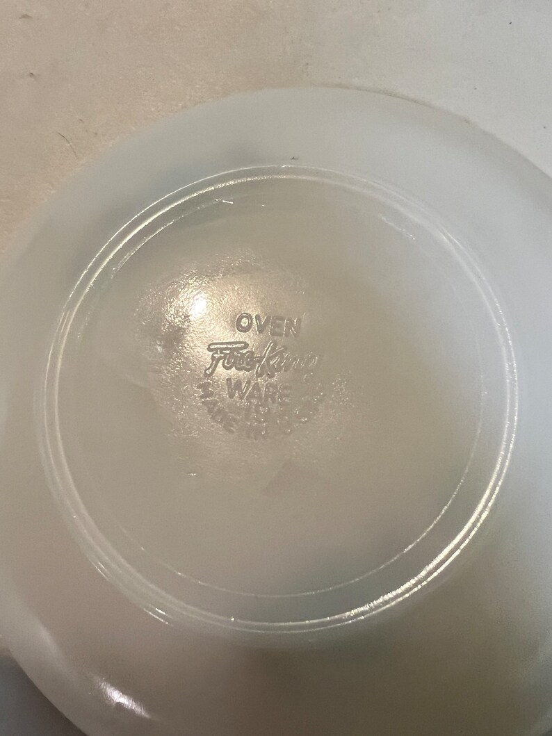May include: White ceramic bowl with the words "OVEN Fire King WARE" printed on the bottom.