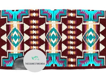 May include: A burgundy, turquoise and white saddle pad with a geometric pattern. The saddle pad has a black leather flap with the text "THEEQUINESTOREINDIA".