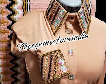 May include: A peach-colored button-down shirt with a rhinestone-embellished collar and cuffs. The collar and cuffs feature black, gold, and iridescent rhinestones. The shirt has a logo that says "Theeequinestoreindia".