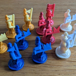 May include: A set of ten game pieces, each featuring a different color and design. The pieces are made of plastic and have a raised design. The colors include yellow, red, blue, and white.
