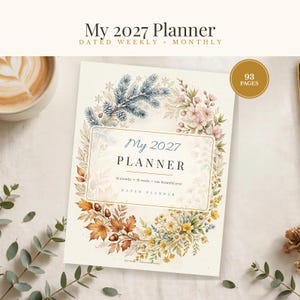 May include: A 2027 planner with a floral and seasonal wreath design on the cover. The text reads My 2027 Planner, 12 months, 52 weeks, one beautiful year, and 93 pages. The wreath features pine branches, pink blossoms, autumn leaves, and yellow flowers.