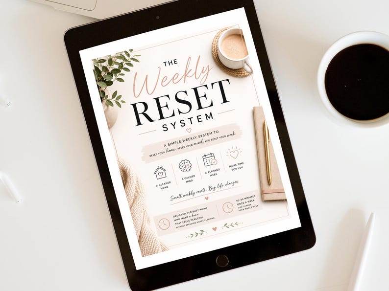 May include: A digital tablet displaying a document titled The Weekly Reset System. The page features text, icons for a home, brain, calendar, and heart, and sections outlining a weekly routine for a cleaner home, calmer mind, and planned week.