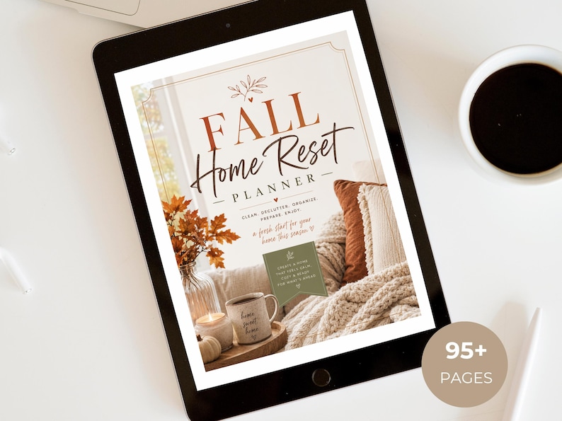 May include: A digital tablet displaying a Fall Home Reset Planner cover page with text, featuring a cozy scene of a mug, candle, and autumn leaves. The screen shows the title Fall Home Reset Planner, clean declutter organize prepare enjoy, and a 95+ pages badge.