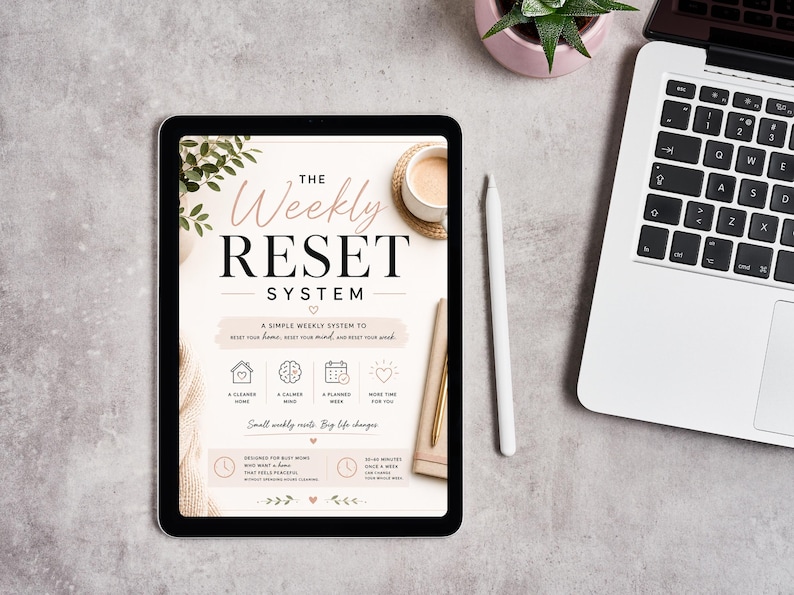 May include: A digital tablet displaying a document titled The Weekly Reset System, featuring a clean layout with icons for home, mind, and planning. The screen includes text about weekly resets, busy schedules, and time management, presented in a soft, neutral color palette with botanical accents.