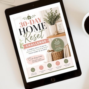 May include: A digital tablet displaying a 30-Day Home Reset Challenge guide. The graphic features text, a photo of a home interior with a plant and basket, and icons for daily tasks. The color palette includes sage green, soft pink, and black.