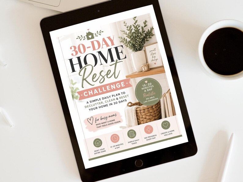 May include: A digital tablet displaying a 30-Day Home Reset Challenge guide. The graphic features text, a photo of a home interior with a plant and basket, and icons for daily tasks. The color palette includes sage green, soft pink, and black.