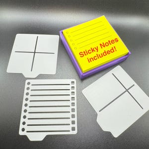 May include: A purple square holder containing a stack of yellow sticky notes with printed lines and circles, accompanied by three white plastic stencils featuring various grid, line, and checklist patterns. The yellow notes display the text Sticky Notes included!