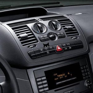 May include: A black dashboard with a silver radio and air vents. The radio display shows "TRACK 6" with the words "RUN", "RPT", and "SC" below.