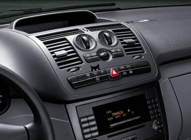 May include: A black dashboard with a silver radio and air vents. The radio display shows "TRACK 6" with the words "RUN", "RPT", and "SC" below.