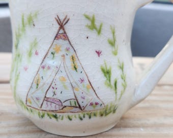 Ceramic mug with tent.