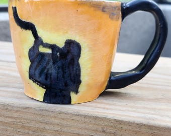 Ceramic mug with man blowing shofar.