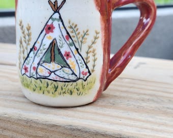 Ceramic mug with tent.