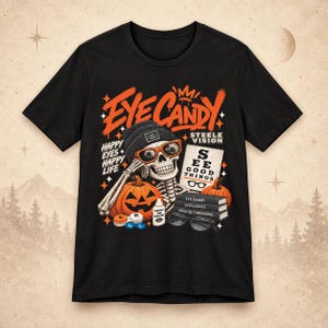 May include: A black t-shirt featuring a graphic of a skeleton wearing a beanie and orange sunglasses. The text reads EYE CANDY, HAPPY EYES HAPPY LIFE, STEELE VISION, SEE GOOD THINGS, EYE EXAMS, EYEGLASSES, and BRIGHTER TOMORROWS with pumpkins.