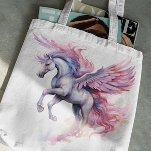 May include: A white tote bag featuring a watercolour illustration of a winged horse with pink and purple wings and a flowing mane. The horse is depicted in a dynamic pose, with its wings spread wide and its head turned to the side.