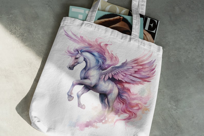 May include: A white tote bag featuring a watercolour illustration of a winged horse with pink and purple wings and a flowing mane. The horse is depicted in a dynamic pose, with its wings spread wide and its head turned to the side.