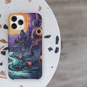 May include: A phone case with a Halloween theme. The case features a spooky house, a creepy tree, and a moon with a face. The colours are purple, blue, orange, and black.