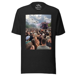 May include: A charcoal gray short-sleeve t-shirt featuring a rectangular graphic print on the chest. The image depicts a large crowd of people at an outdoor event with several white horses appearing to fly in the cloudy sky above the gathering.