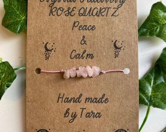 May include: A handmade pink rose quartz bracelet on a brown card with the text "Crystal Jewellery Rose Quartz Peace & Calm Hand made by Tara".