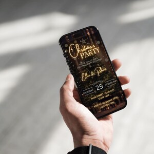 May include: A smartphone displays a Christmas party invitation. The invitation features gold text that reads "Christmas Party" and "Ellie & Robert." The date is December 25th at 8:00 PM. The phone is held in a person's hand.