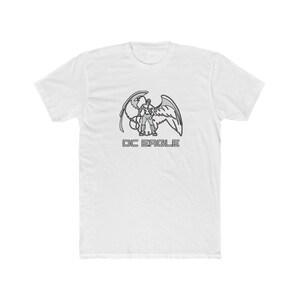 May include: White t-shirt featuring a gray graphic of a figure with large wings, and the text "DC EAGLE" in gray. The design is centered on the front of the shirt, creating a bold statement.