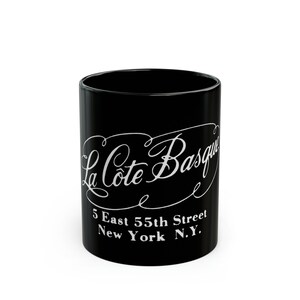May include: Black ceramic mug with white lettering that reads "La Cote Basque" and "5 East 55th Street New York N.Y."