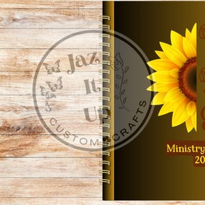 May include: A spiral-bound planner with a sunflower design. The right side features a yellow and brown gradient with the words "Best Life Ever" and "Ministry Planner 2026". The left side has a wood grain pattern and a circular logo.
