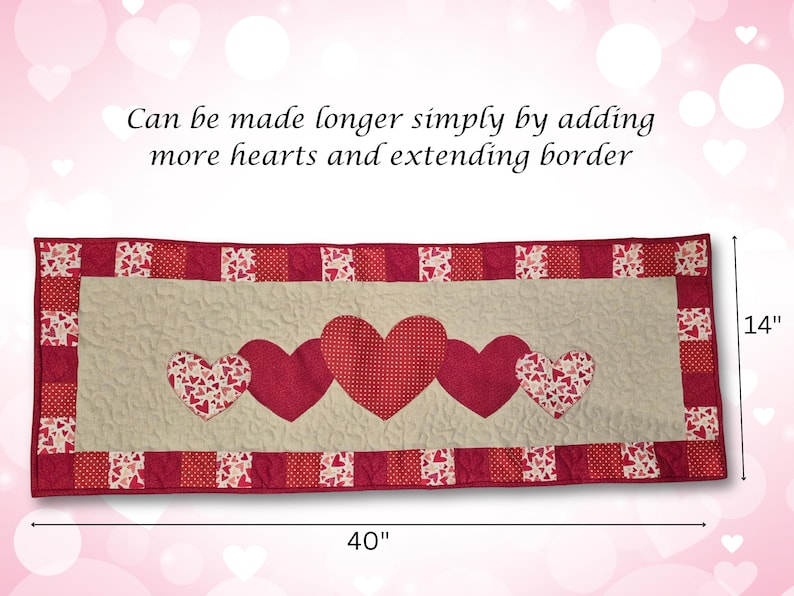 May include: A quilted table runner featuring a cream-colored center with five red hearts. The runner is 40 inches long and 14 inches wide, with a red border. The text says, "Can be made longer simply by adding more hearts and extending border."