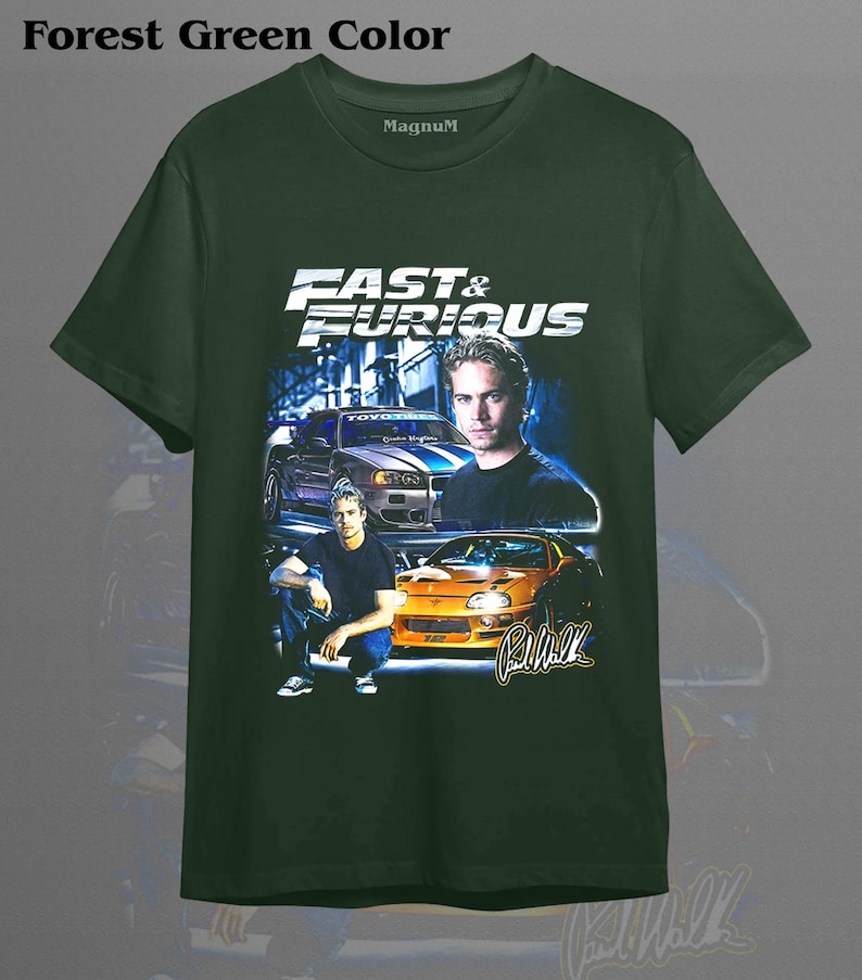 May include: Forest green t-shirt featuring the text "Fast & Furious" with images of cars and Paul Walker. The shirt has a crew neck and short sleeves. The brand name "Magnum" is printed on the shirt.