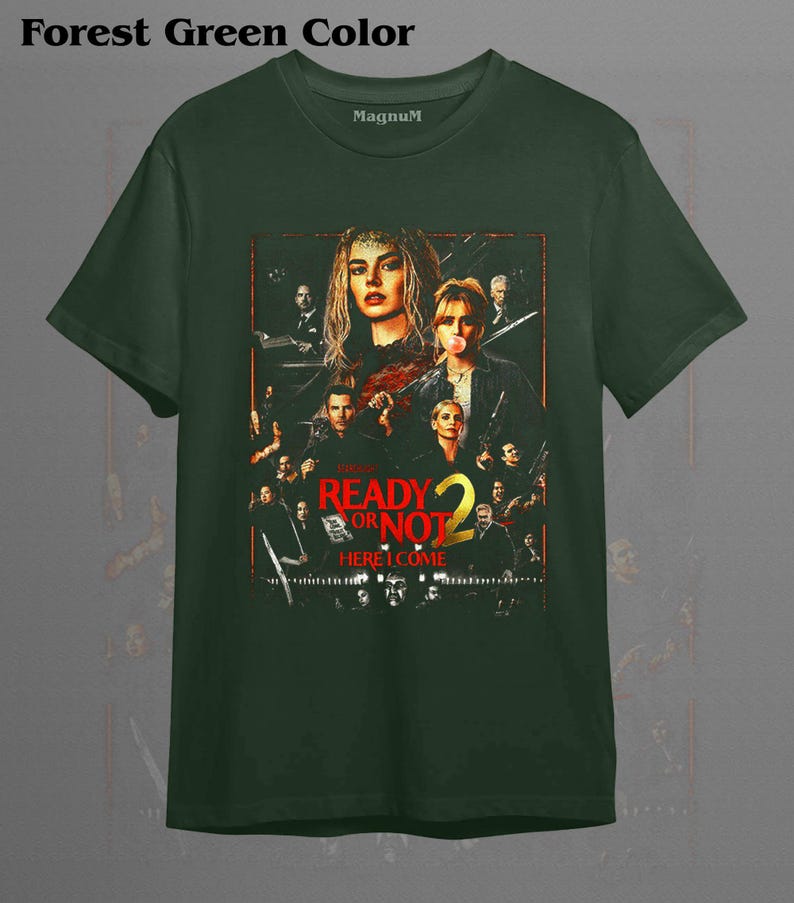 May include: A forest green short-sleeve t-shirt featuring a graphic print of the movie poster Ready or Not 2 Here I Come. The design includes multiple character portraits in a dark, cinematic style with red and yellow text accents on the front.
