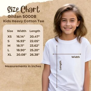May include: A size chart for the Gildan 5000B Kids Heavy Cotton Tee, displaying width and length measurements in inches for sizes XS through XL. The chart lists XS as 16.14 by 20.47 inches, S as 16.93 by 22.05 inches, M as 18.11 by 23.62 inches, L as 18.90 by 25.20 inches, and XL as 20.08 by 26.38 inches.