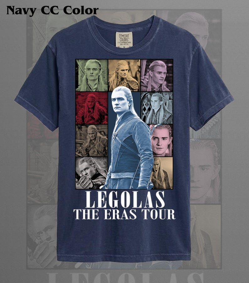 May include: Navy blue t-shirt featuring a collage of images of Legolas from The Lord of the Rings. The graphic includes multiple portraits and the text "LEGOLAS THE ERAS TOUR" in white. The shirt is made of a soft material and has a crew neck.