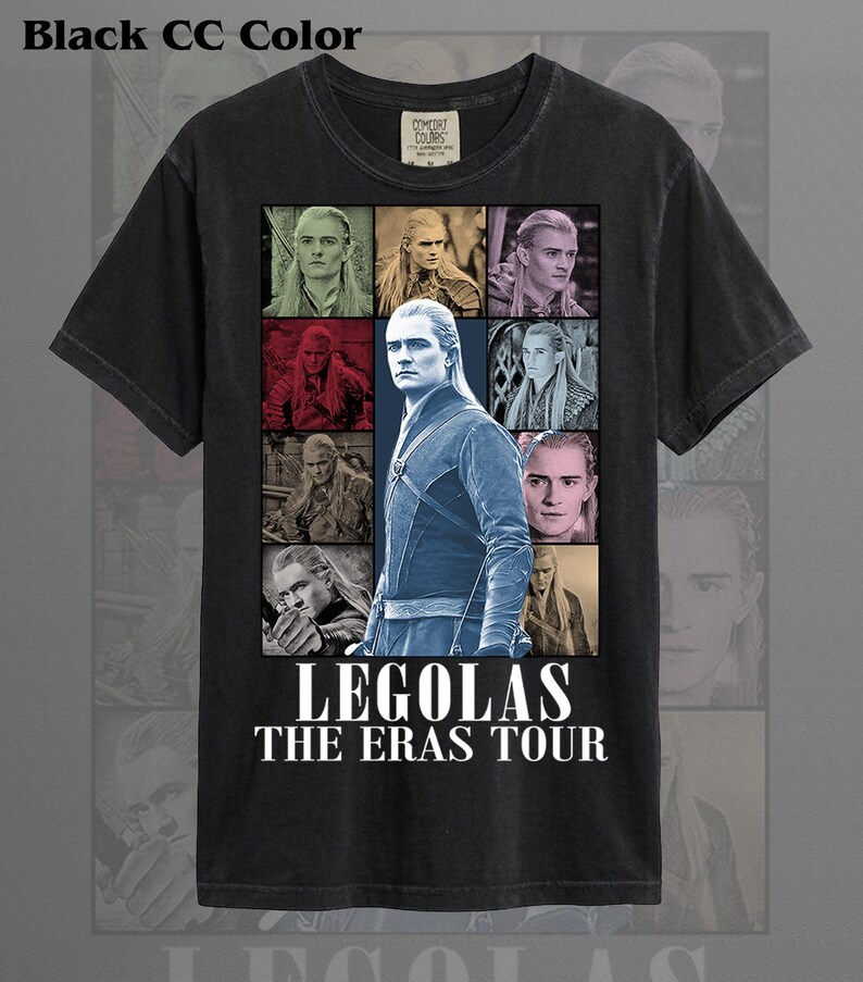 May include: Black t-shirt featuring a collage of images of Legolas from The Lord of the Rings. The design includes the text "LEGOLAS THE ERAS TOUR" in white. The shirt is made of a soft material.