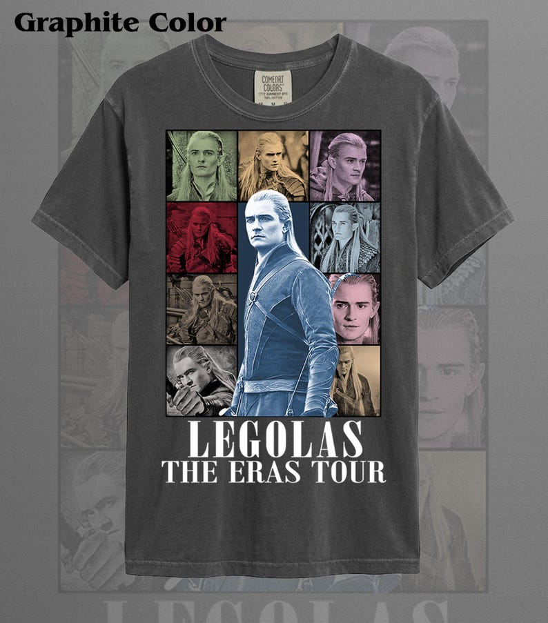 May include: Graphite-colored t-shirt featuring a collage of images of Legolas from The Lord of the Rings. The shirt includes the text "LEGOLAS THE ERAS TOUR" in white font. The shirt is made of a soft material.