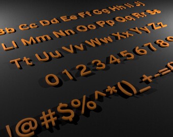 May include: Orange 3D alphabet letters, numbers, and symbols are arranged on a dark gray surface. The letters include uppercase and lowercase, with numbers 0-9 and symbols like !, @, #, $, %, ^, *, (, ), _, +, -, and =.