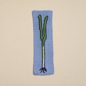 K&ouml;nnte beinhalten: Ein geh&auml;keltes Wandbild mit einem gr&uuml;nen und wei&szlig;en Lauch auf hellblauem Hintergrund.