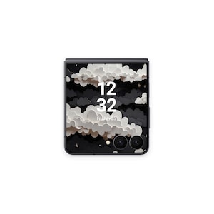 May include: A closed, black smartphone with a cloud-themed wallpaper. The screen displays the time as 12:32 and the date as Friday, July 25. The phone has a dual-lens camera and a sleek, modern design.