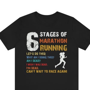 May include: Black t-shirt with a vintage-style graphic that says "6 Stages of Marathon Running" and lists the stages of running a marathon. The graphic includes a running figure.
