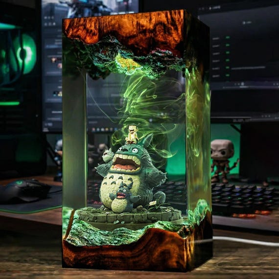 Totoro captured inside a glowing hand-poured epoxy wood diorama lamp — a collector-grade anime art piece, not a mass merch trinket.