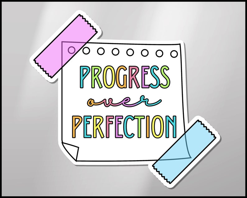 May include: A white note with a black outline and a torn corner, with the text "PROGRESS over PERFECTION" written in colorful letters. The note is attached to a gray background with two pieces of tape, one pink and one blue.