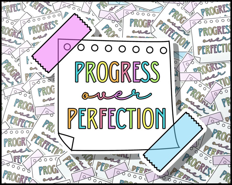 May include: A white note with a colorful handwritten message that says "Progress over Perfection" surrounded by smaller notes with the same message. The note is decorated with pink and blue washi tape.